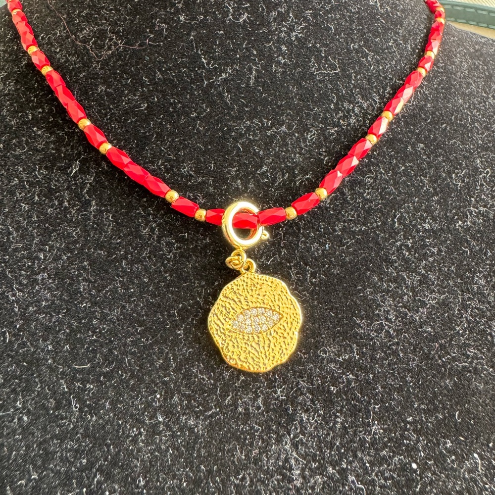Red glass crystal and gold silverr bead necklace with  gold to ned eye pendant